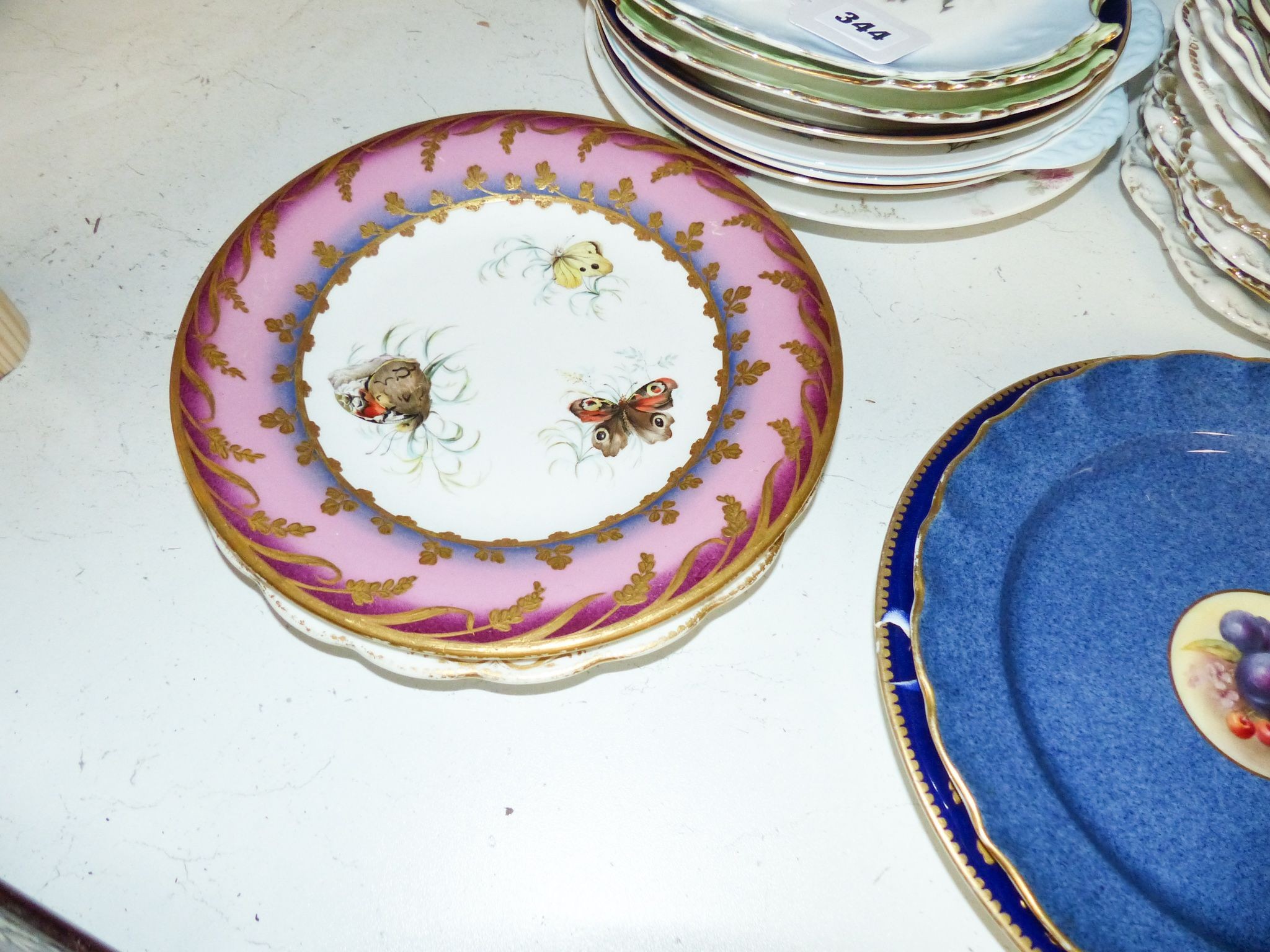 A collection of 19th/20th century Continental porcelain wall plates including a Royal Worcester powder blue fruit painted plate signed W. Bee, 23cm